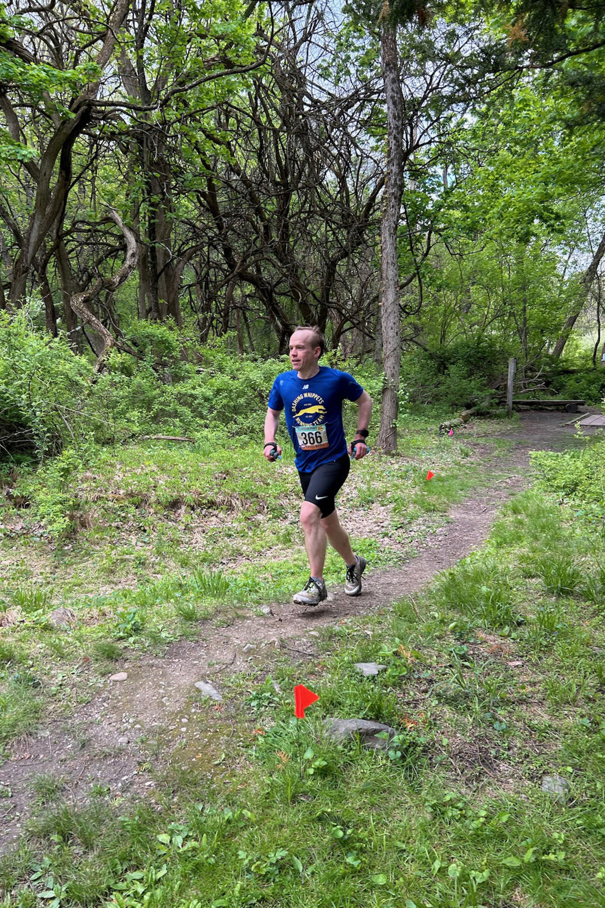 Runner moving along a sunlit mountain trail